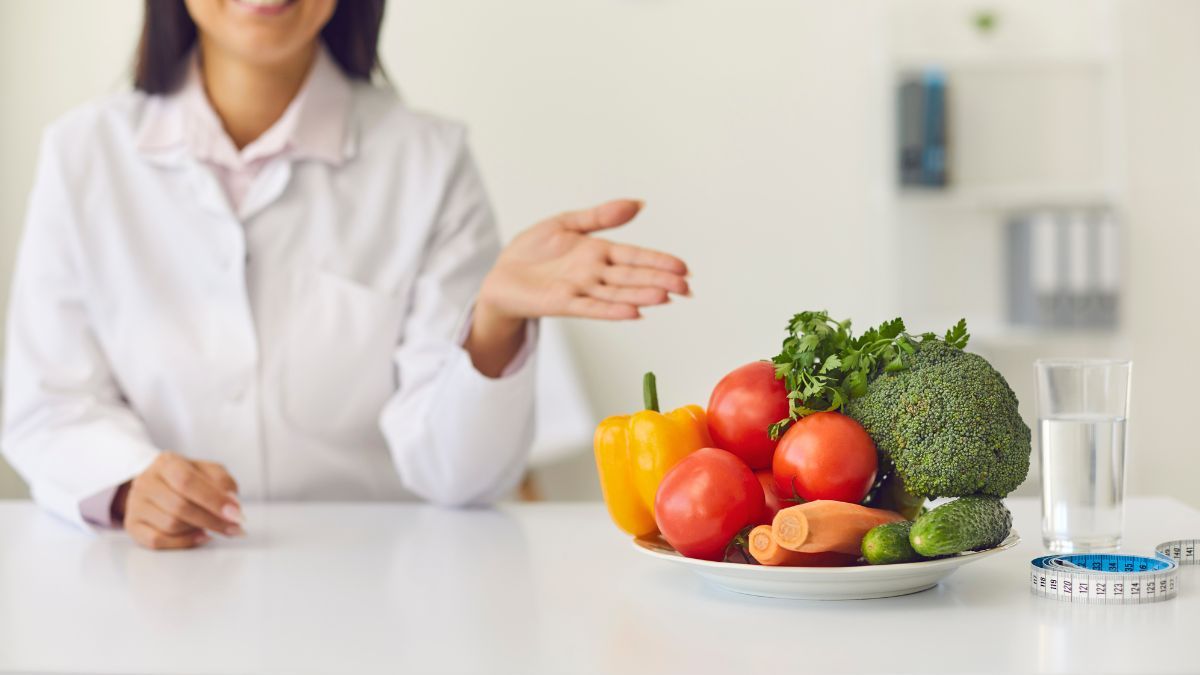 Doctor Presenting Healthy Vegetables On A Plate