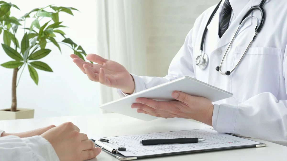 Doctor Explaining To A Patient Using A Tablet During A Consultation